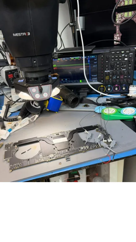 Corroded component micro-soldering under 40x microscope on a water-damaged MacBook in Dubai — MacTech Pro
